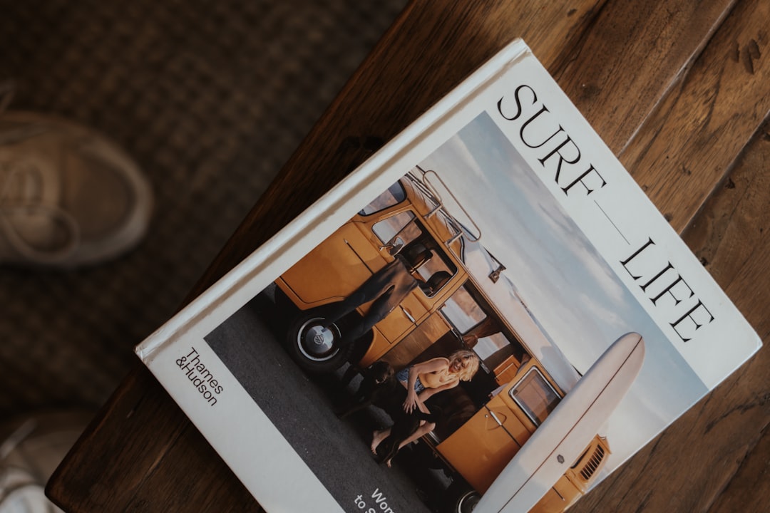 A "surf life" magazine sits on a wooden table.